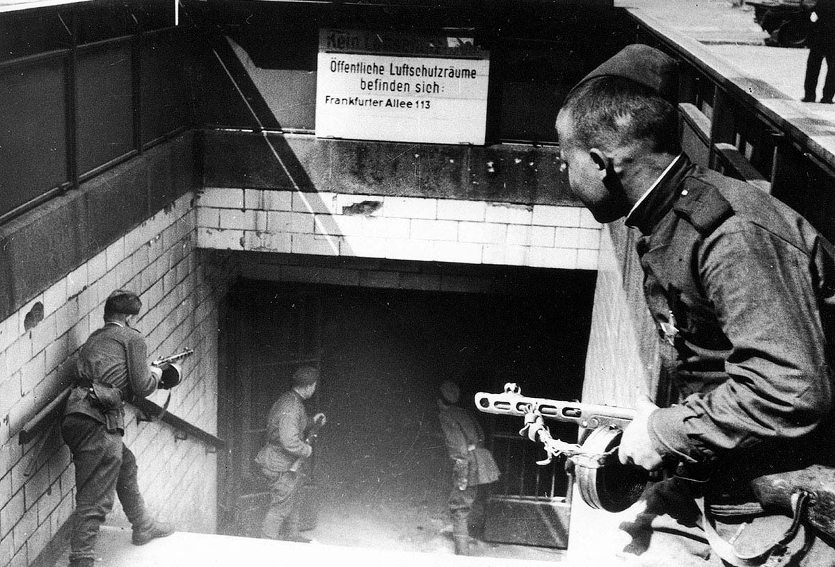 Soviet Red Army troops pose at the entrance to Frankfurter Allee underground station during the Battle of Berlin, 1945