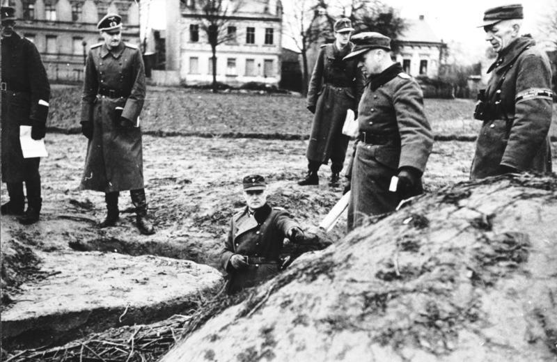 Generalleutnant Hellmuth Reymann inspecting a defensive position with soldiers and Volkssturm men