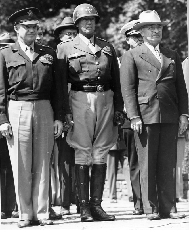 The Potsdam Conference - July 20th 1945 - General Dwight Eisenhower, General George Patton, and President Harry S. Truman. The Flag of Liberation is being raised over the former Nazi headquarters in Berlin.