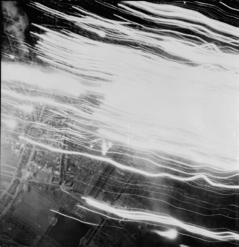 View from an RAF bomber over Cologne - May 1942 - with the searchlights and tracer fire visible - Public Domain