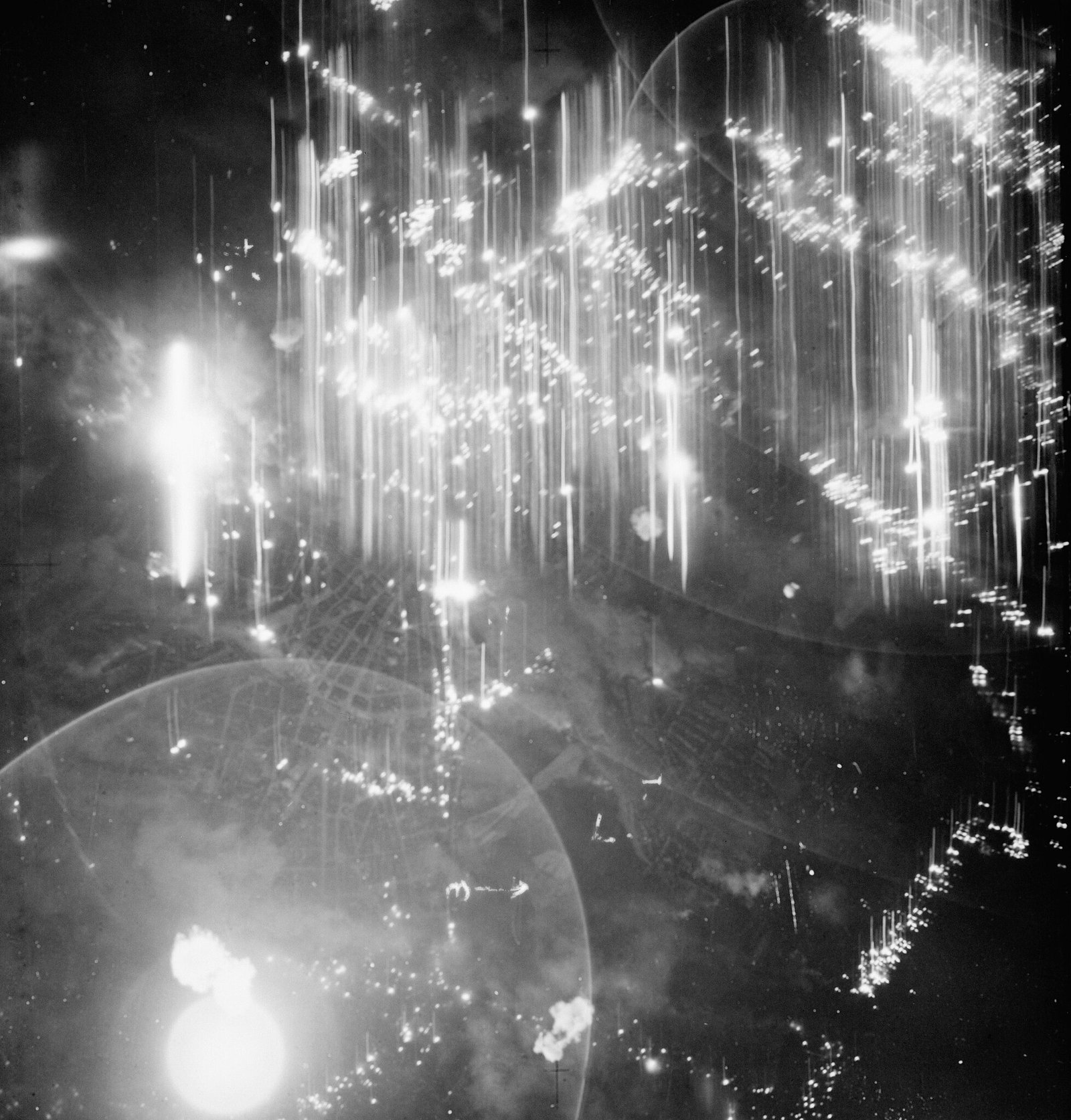 Aerial photo taken during the night raid on Hamburg on July 25th/25th 1943. Sticks of incendiaries are burning in the Altona and Dock districts - Public Domain