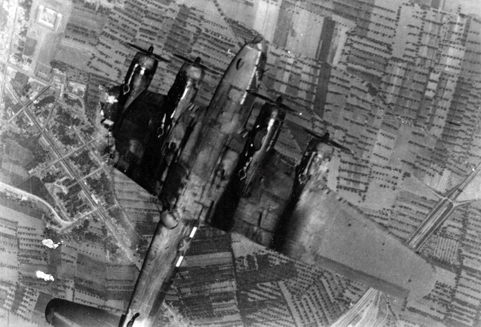 A flak damaged B-17 is captured upside down while falling over Schweinfurt during 'Black Week' (1943) - Public Domain