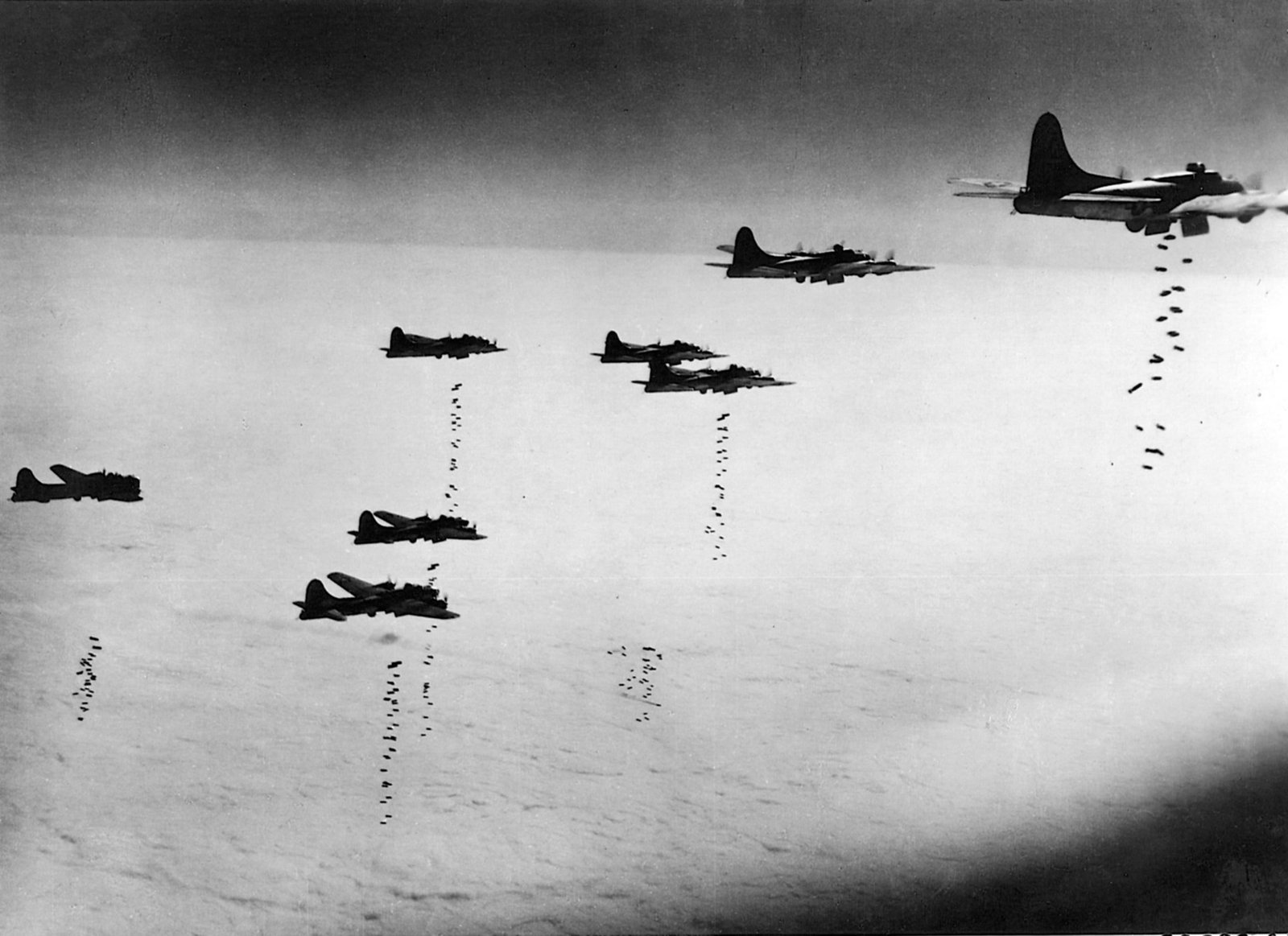 A formation of US B-17s sends its bombs away on a cloudy day in March 1945 - Public Domain