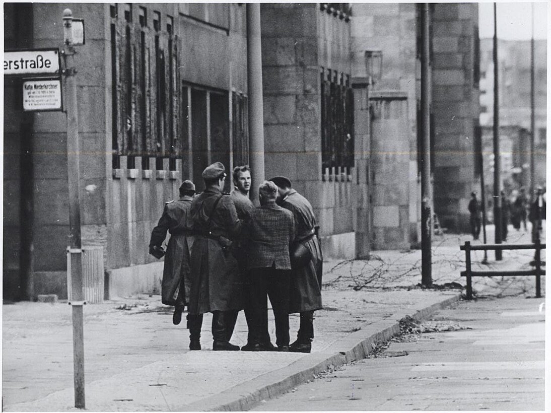 An East Berliner is seized by the East German police as he attempts to escape to the West (August 1961) - Public Domain