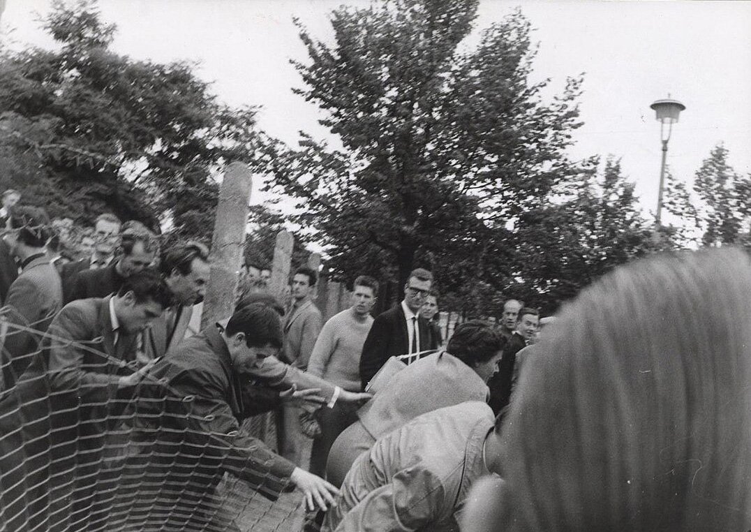 "While West Berliners distract the East German guards, a few lucky East Berliners make it over the fence to freedom." - August 26th 1961 - CIA/Public Domain