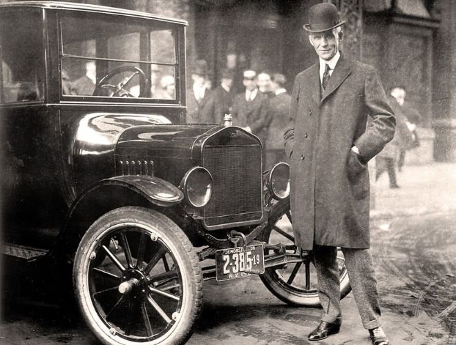 Henry Ford stood next to a Ford T-model - Public Domain