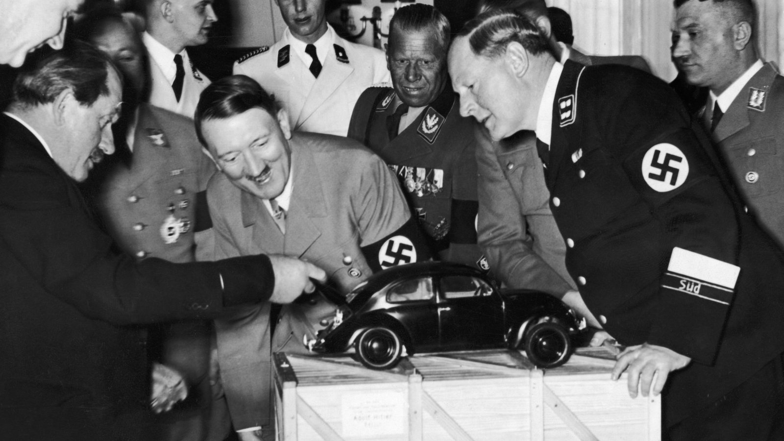 Ferdinand Porsche unveiling the concept Volkswagen KdF-Wagen - the Beetle - to Adolf Hitler (1934)- Public Domain