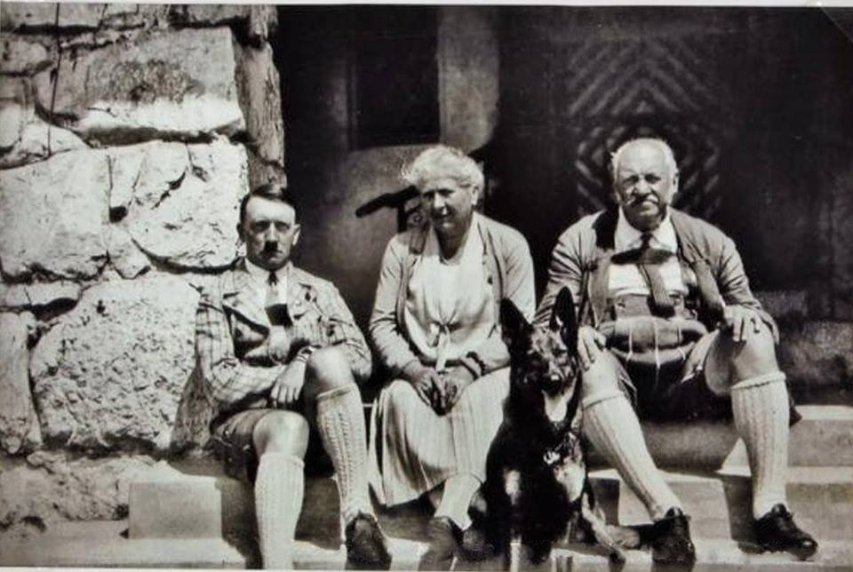 Adolf Hitler sitting with his dog Prinz and Helene and Edwin Bechstein of the Bechstein Piano business (1925) - Public Domain