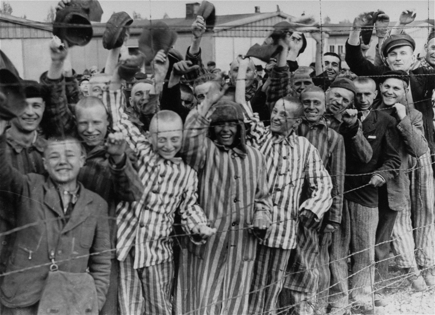 Prisoners at Dachau Concentration Camp following their liberation (1945) - Public Domain