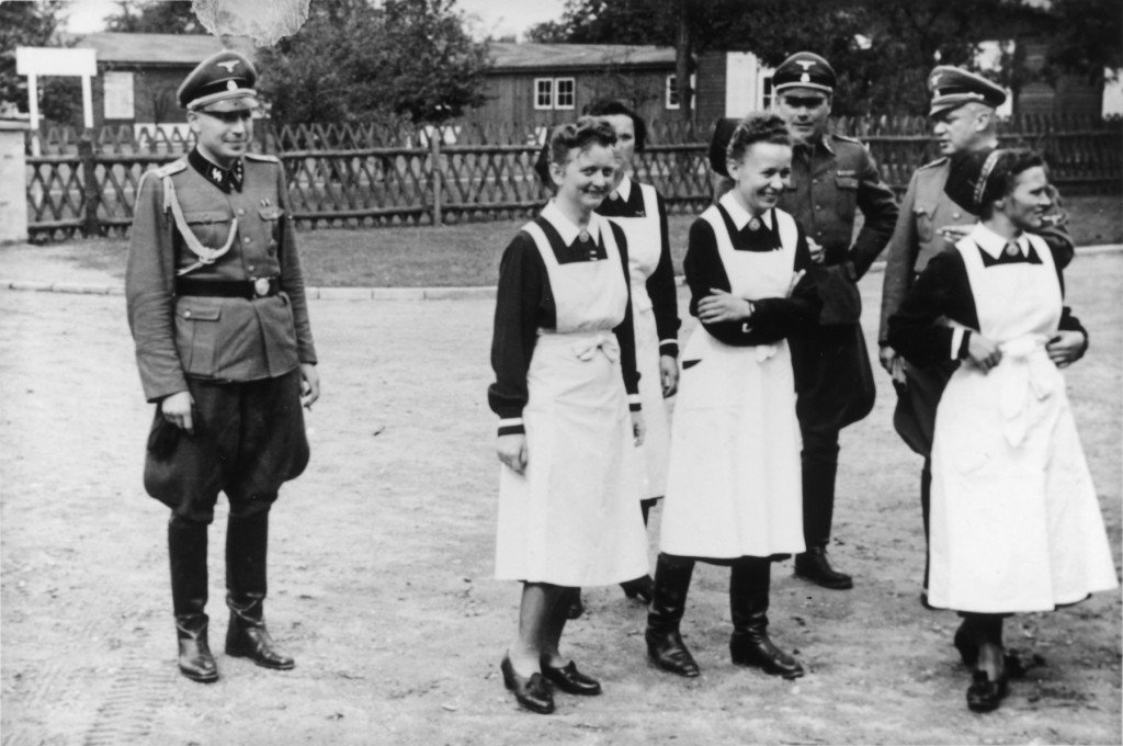 SS officers and German nurses gather during the dedication ceremony of the new SS hospital in Auschwitz (1944) - US Holocaust Memorial Museum