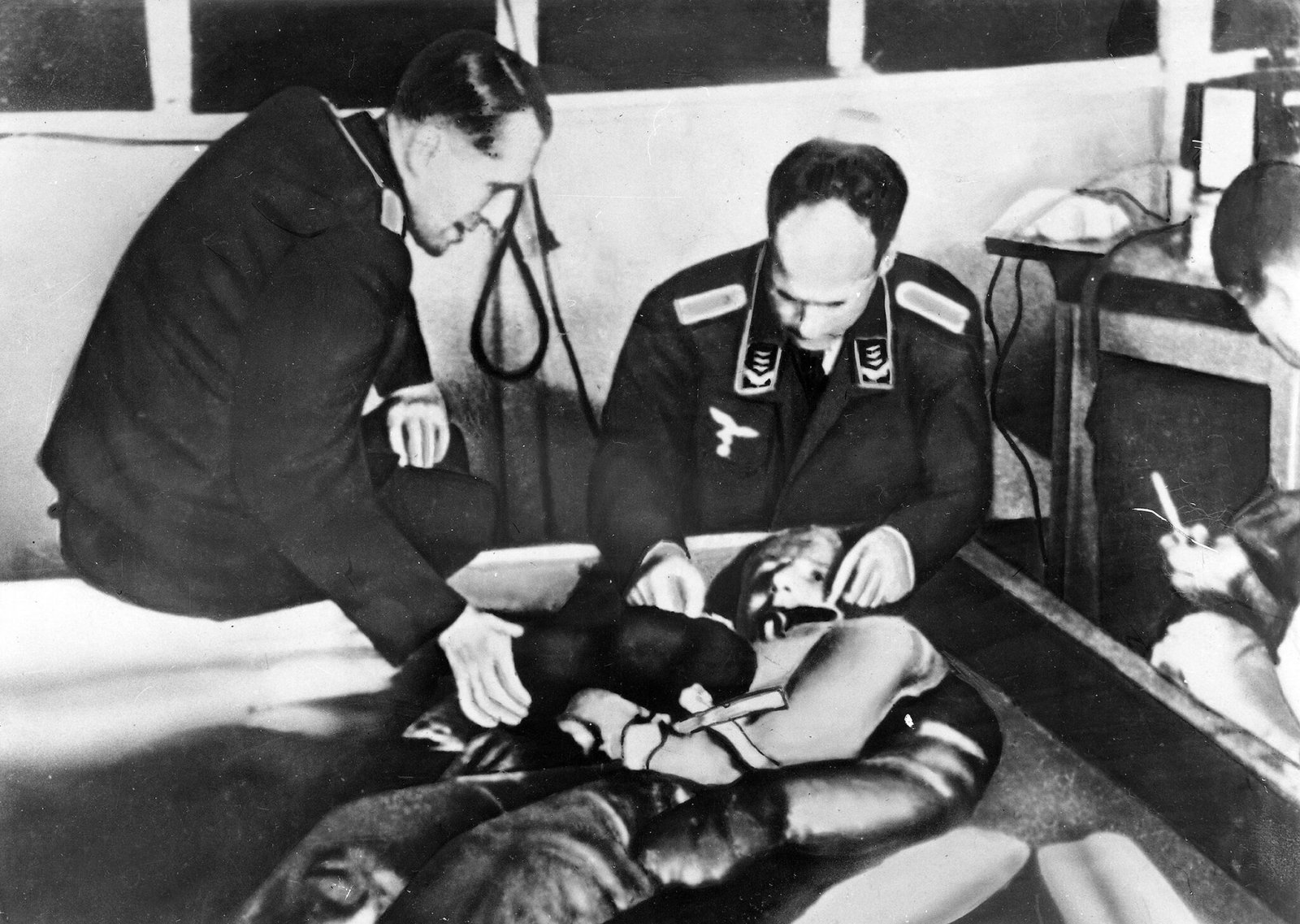 A cold water immersion experiment at Dachau concentration camp presided over by Ernst Holzlöhner (left) and Sigmund Rascher (right) - Public Domain
