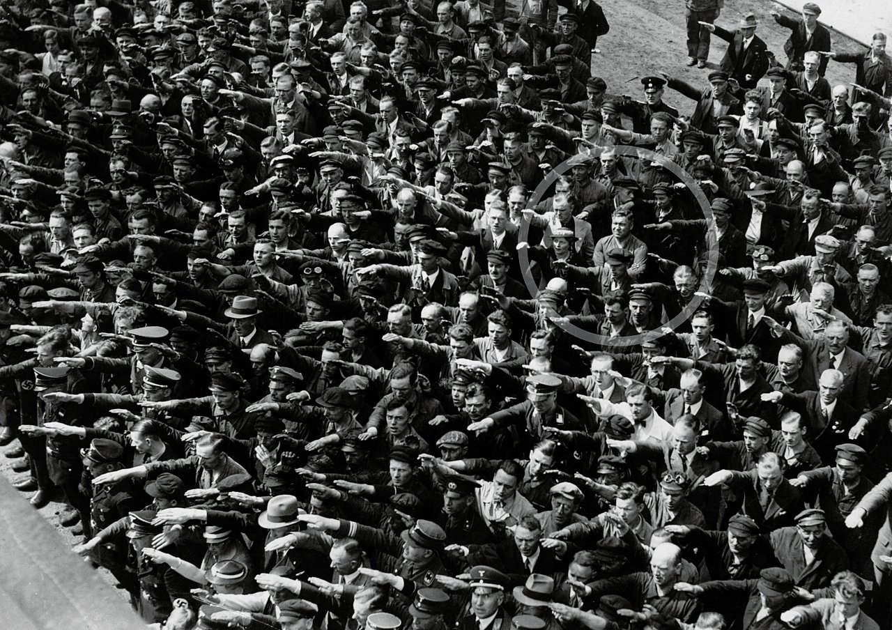 August Landmesser (or possibly Gustav Wegert) refuses to give a Nazi salute at the Blohm and Voss in Hamburg (1936) during the launch of the training ship 'Horst Wessel' - Public Domain