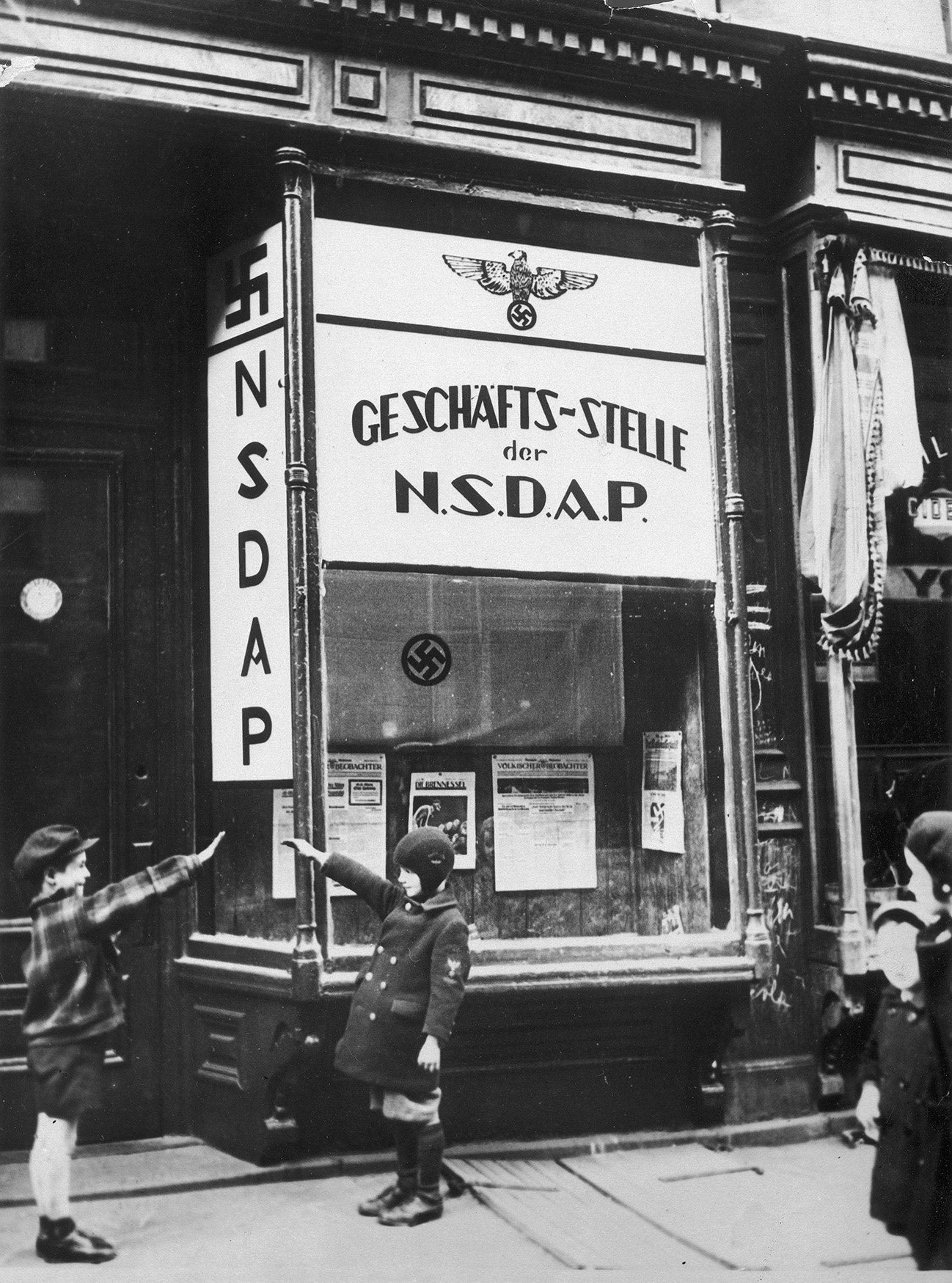 Children saluting outside the newly opened headquarters of the NSDAP (National Socialist German Workers' Party) in Yorkville, New York City, April 1932 - Public Domain