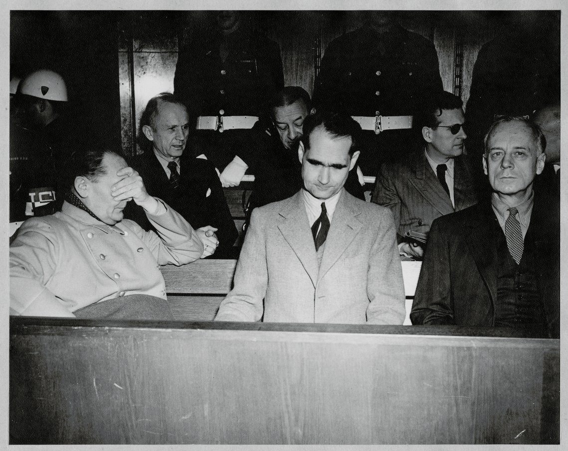 Rudolf Hess (centre) at the Nuremburg Trials (1945-46) - Public Domain