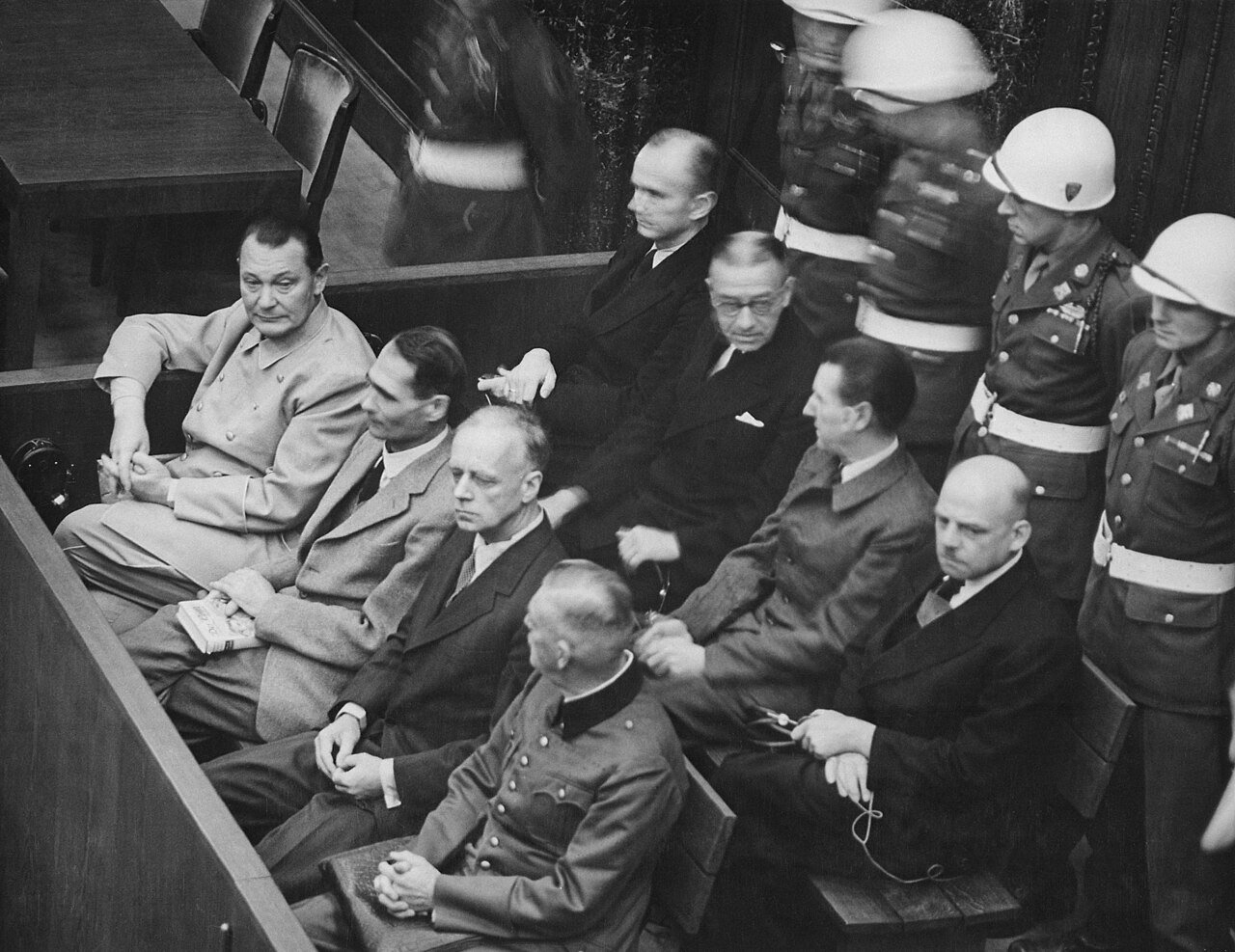 Nuremberg Trials. Defendants in their dock (1945) - Hermann Göring, Rudolf Heß, Joachim von Ribbentrop, Wilhelm Keitel - second row: Karl Dönitz, Erich Raeder, Baldur von Schirach, Fritz Sauckel - Public Domain