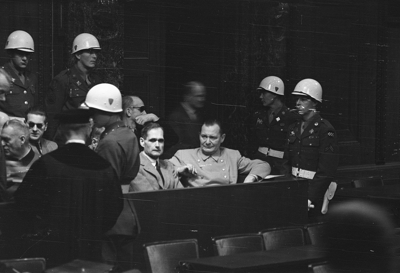 Rudolf Hess (centre) and Hermann Göring at the Nuremberg Trial (December 1945) - Public Domain