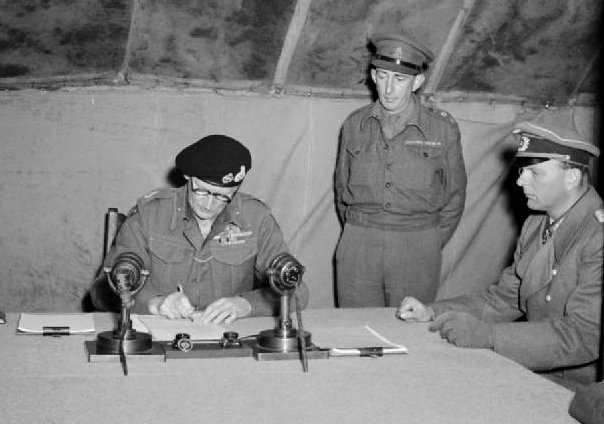 Field Marshal Montgomery adds his signature to the document of surrender signed by the German delegation at 21st Army Group HQ at Luneburg Heath (May 4th 1945) - Public Domain