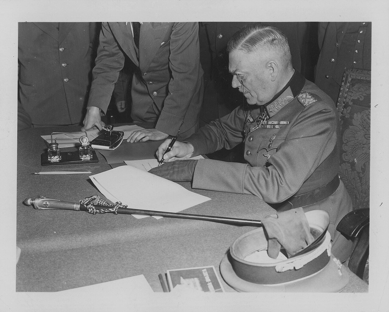 Field Marshal Wilhelm Keitel, C-in-C of the German armed forces, signs the unconditional surrender at Karlshorst, Berlin (May 8th1945) - Public Domain