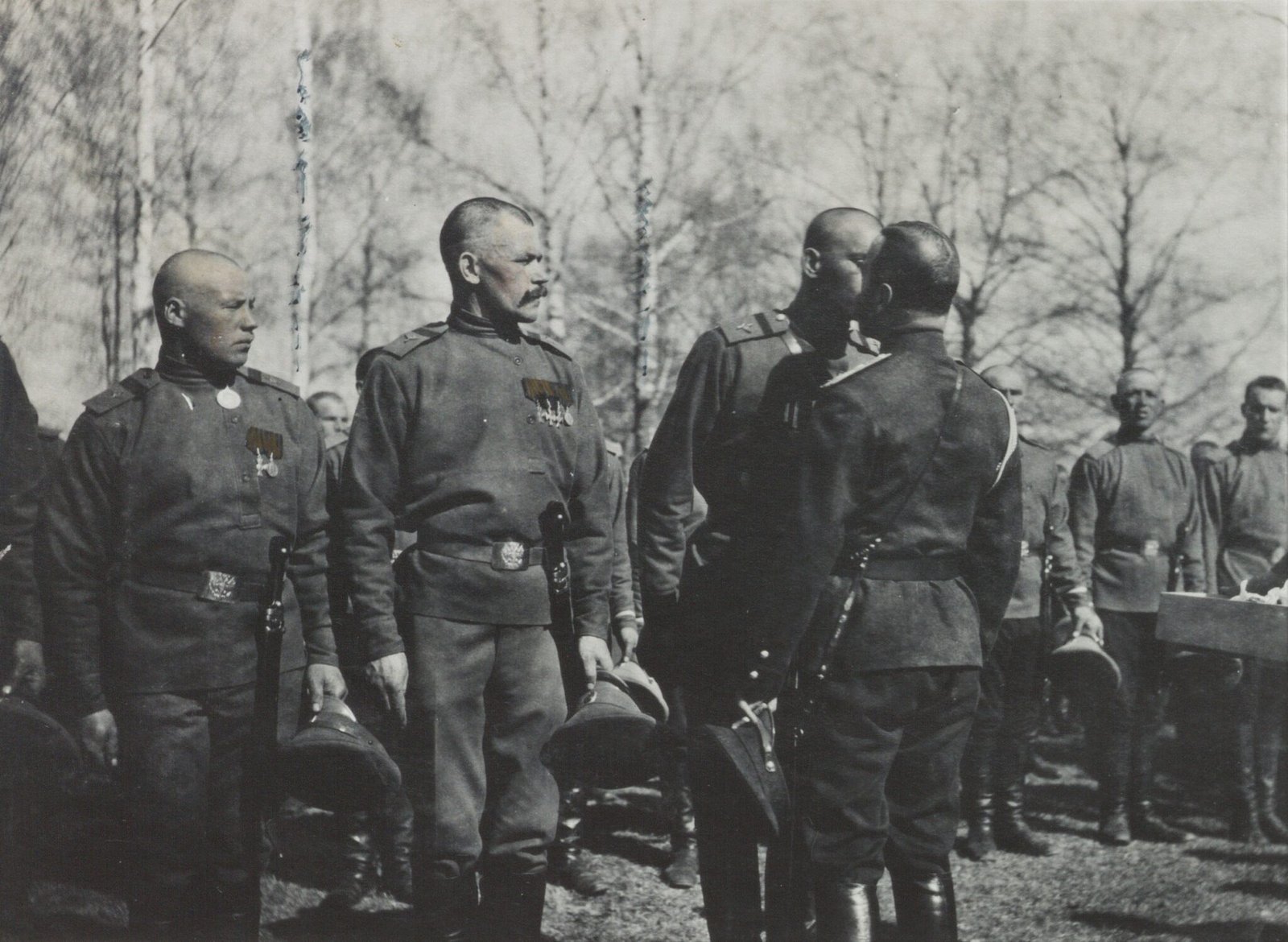 Russian Tsar, Nicholas II, gives a holy kiss to a male soldier (1916) - Public Domain