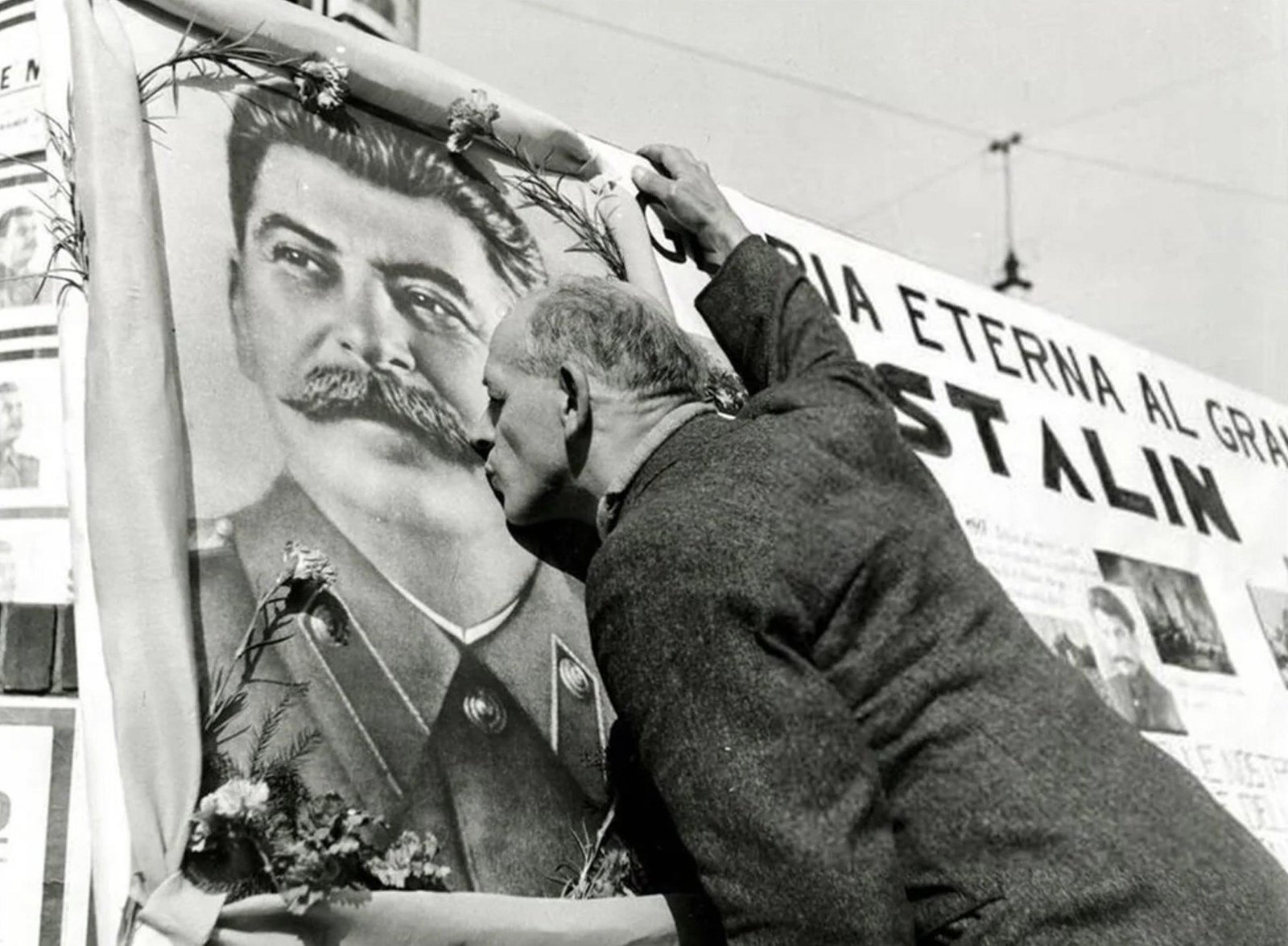 An Italian man kissing an image of Soviet leader Joseph Stalin after his death in 1953 - Public Domain