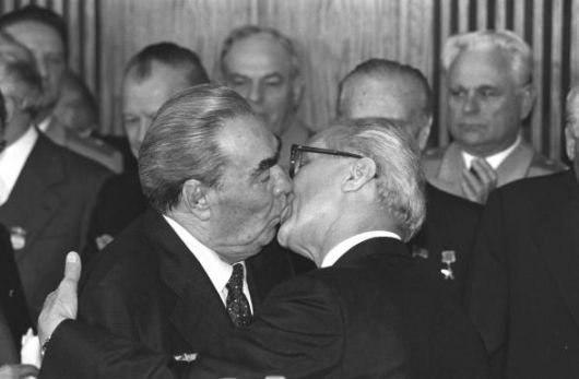 Leonid Brezhnev & Erich Honecker embrace in a Socialist Kiss in 1979 - Public Domain