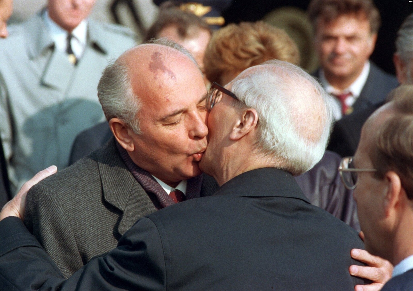 Mikhail Gorbachev and Erich Honecker embracing in a Socialist Kiss - Public Domain